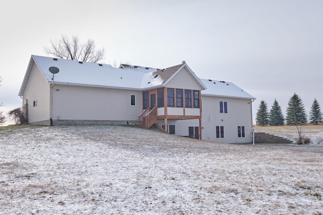 rear view of property featuring a sunroom