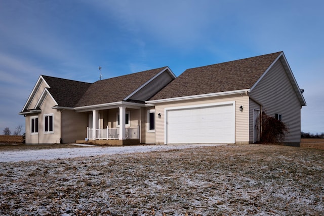 view of front of property featuring a porch and a garage