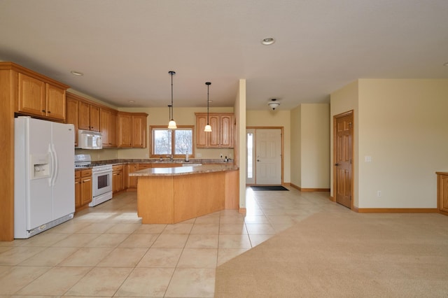 kitchen featuring kitchen peninsula, light tile patterned floors, white appliances, and decorative light fixtures