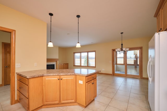 kitchen featuring an inviting chandelier, white refrigerator with ice dispenser, kitchen peninsula, decorative light fixtures, and light tile patterned floors