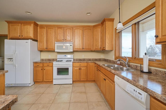 kitchen featuring pendant lighting, white appliances, sink, and light tile patterned floors