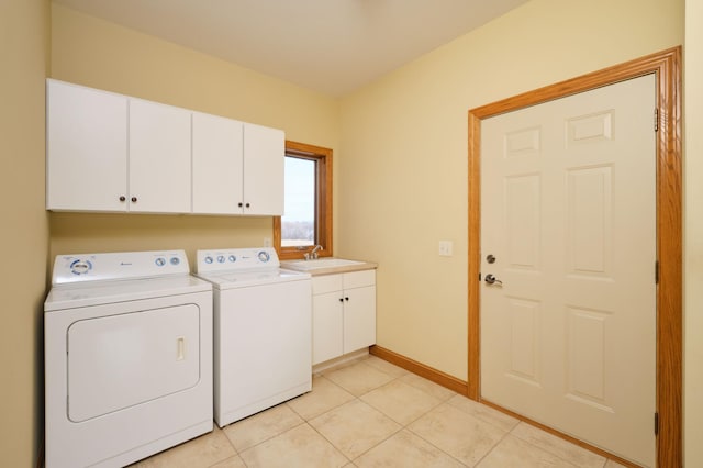 clothes washing area featuring cabinets, light tile patterned floors, separate washer and dryer, and sink