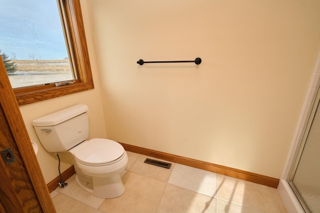 bathroom featuring toilet and tile patterned floors