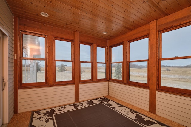 unfurnished sunroom featuring plenty of natural light and wooden ceiling