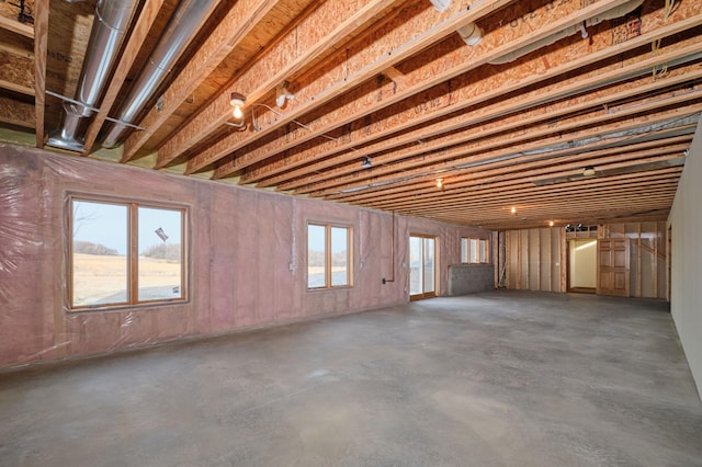 miscellaneous room with a healthy amount of sunlight and concrete flooring