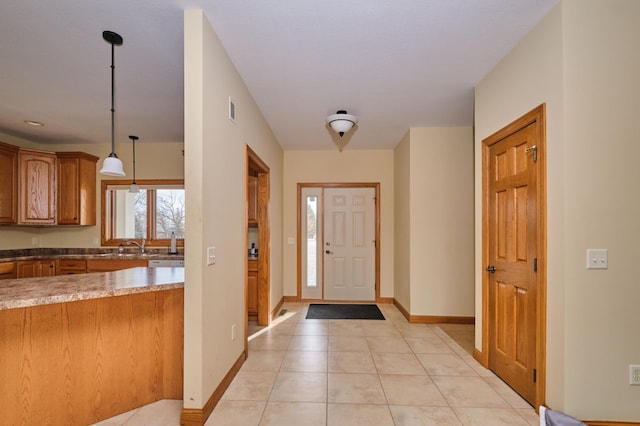 entryway with light tile patterned floors