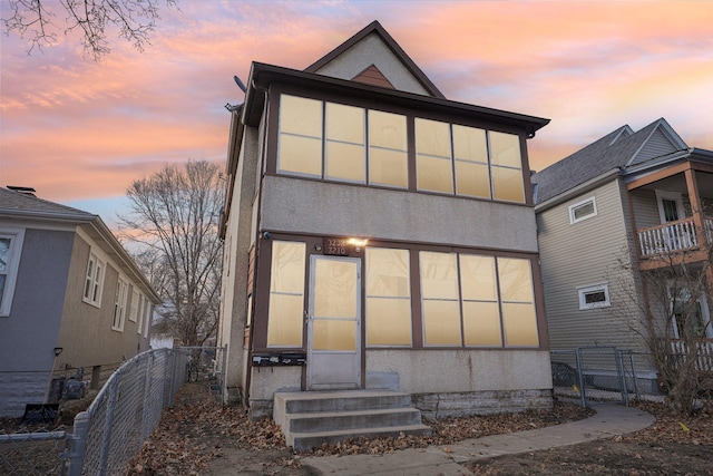 back of property with fence and stucco siding