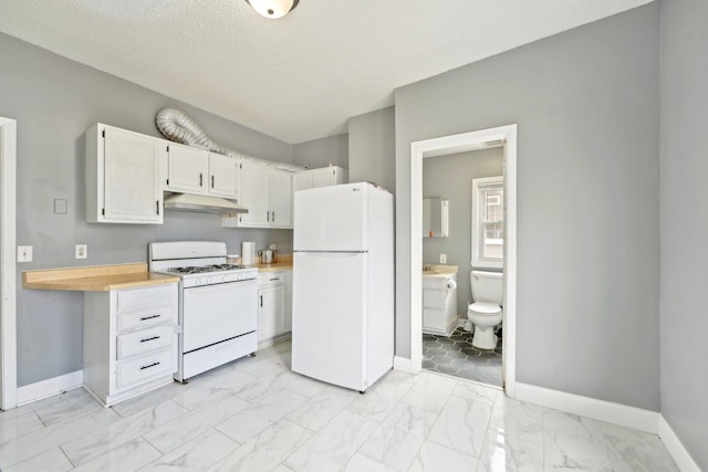 kitchen with white appliances, baseboards, under cabinet range hood, and marble finish floor