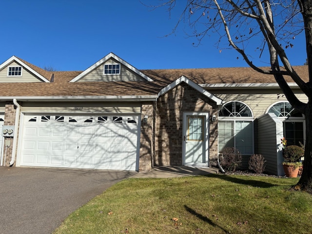 ranch-style home with a garage and a front lawn