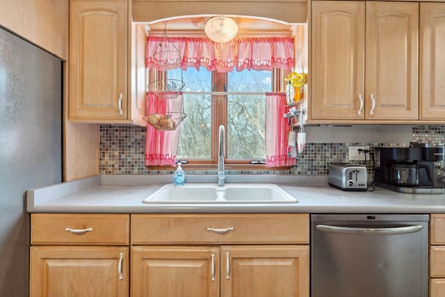 kitchen with sink, light brown cabinets, appliances with stainless steel finishes, and tasteful backsplash