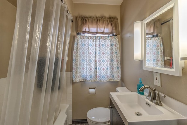 full bathroom with toilet, vanity, and shower / bath combo with shower curtain