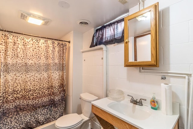 bathroom featuring toilet, vanity, and a shower with shower curtain