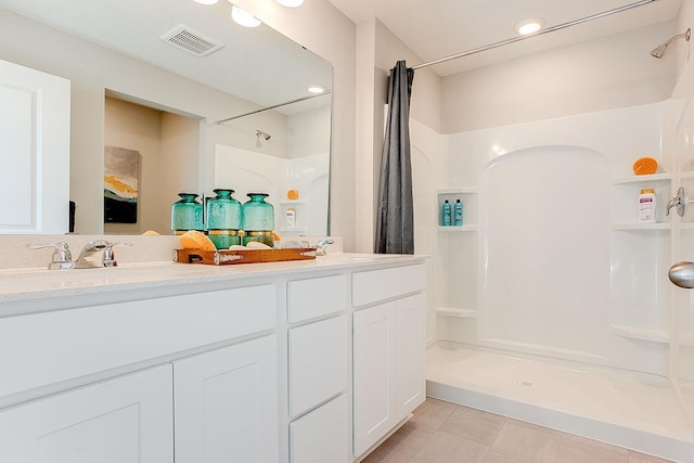 bathroom featuring curtained shower and vanity