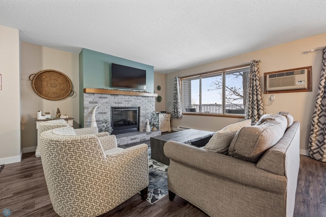 living room with a textured ceiling, a fireplace, and wood-type flooring