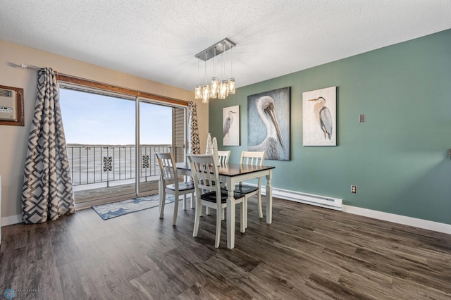 dining space featuring dark hardwood / wood-style flooring, an inviting chandelier, a textured ceiling, and a baseboard radiator