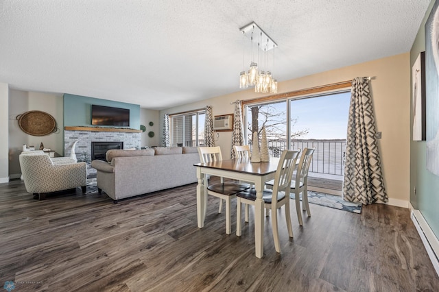 dining space featuring a notable chandelier, a wall mounted air conditioner, a textured ceiling, dark hardwood / wood-style flooring, and a baseboard radiator