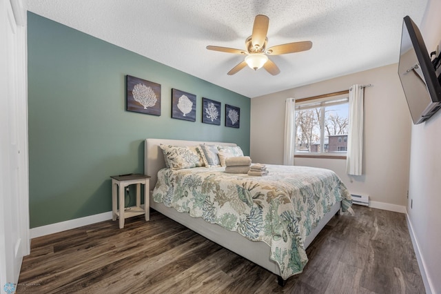 bedroom with ceiling fan, dark hardwood / wood-style floors, and a textured ceiling