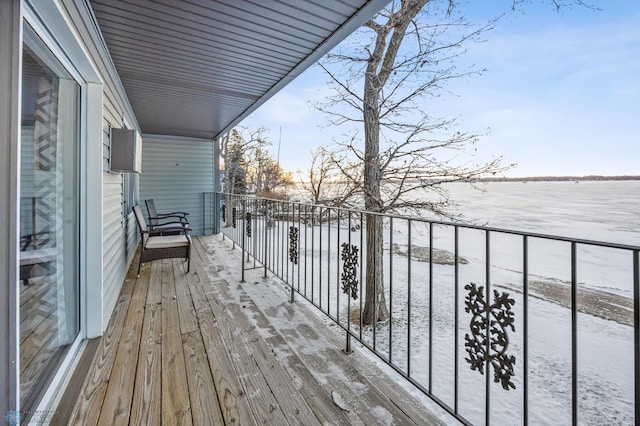 view of snow covered back of property