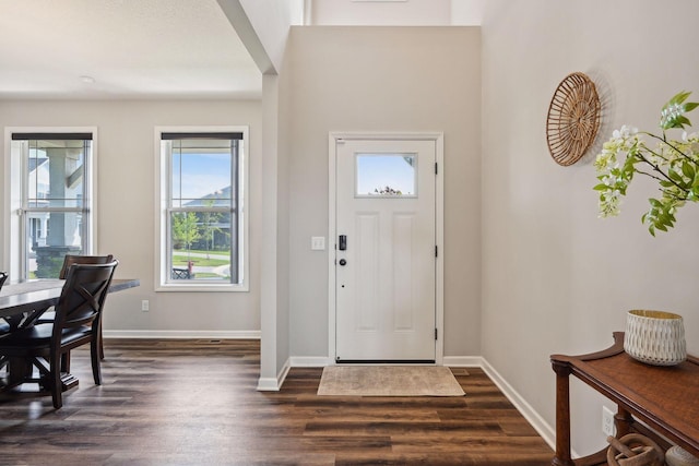 foyer featuring dark wood-style floors and baseboards