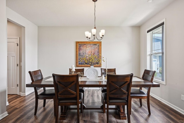 dining room with a chandelier, baseboards, and dark wood finished floors