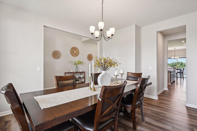 dining room with a chandelier, baseboards, and dark wood finished floors