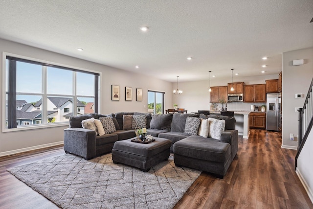 living area featuring dark wood-type flooring, recessed lighting, and a chandelier