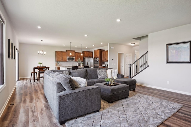 living area with baseboards, recessed lighting, and wood finished floors