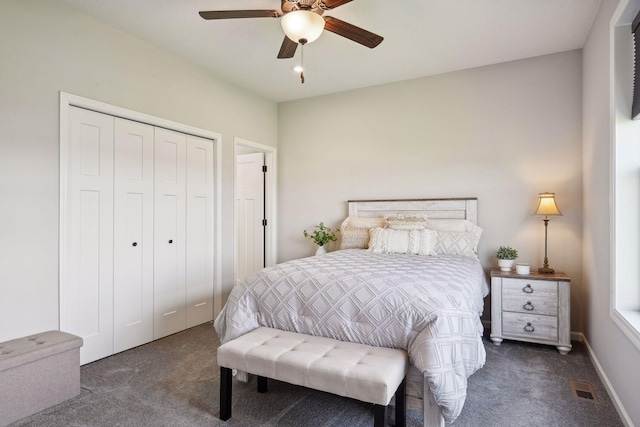 carpeted bedroom featuring baseboards, visible vents, a closet, and a ceiling fan
