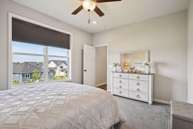 carpeted bedroom featuring ceiling fan and baseboards