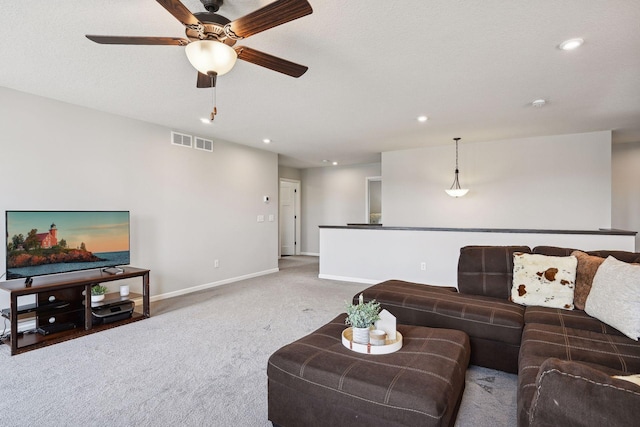 carpeted living area featuring ceiling fan, baseboards, visible vents, and recessed lighting