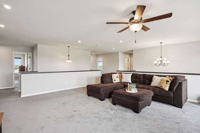 living room featuring recessed lighting, carpet, ceiling fan with notable chandelier, and baseboards