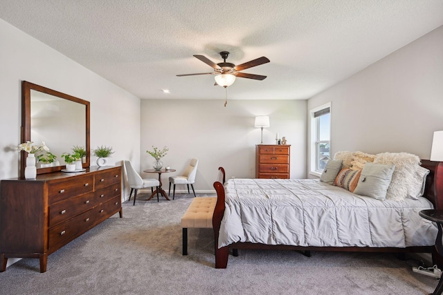 bedroom featuring a textured ceiling, carpet flooring, and ceiling fan