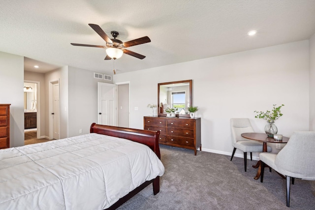 bedroom featuring connected bathroom, a textured ceiling, visible vents, carpet flooring, and baseboards