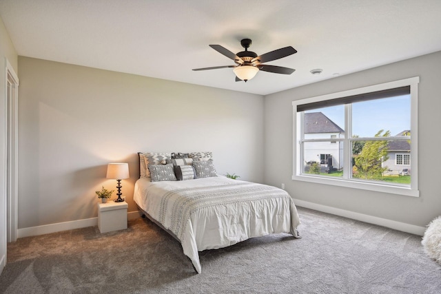 carpeted bedroom with baseboards and ceiling fan