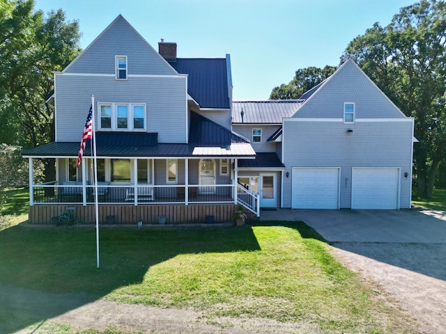 view of front of home with a porch, a garage, and a front lawn