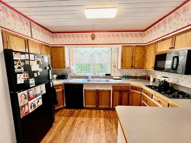 kitchen featuring wood ceiling, sink, black appliances, and light hardwood / wood-style flooring