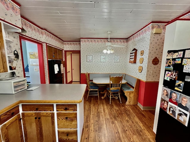 kitchen with refrigerator, crown molding, a chandelier, light hardwood / wood-style floors, and hanging light fixtures