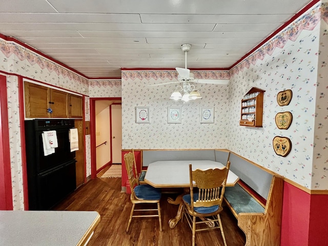 dining room featuring dark hardwood / wood-style flooring, wooden ceiling, and ornamental molding