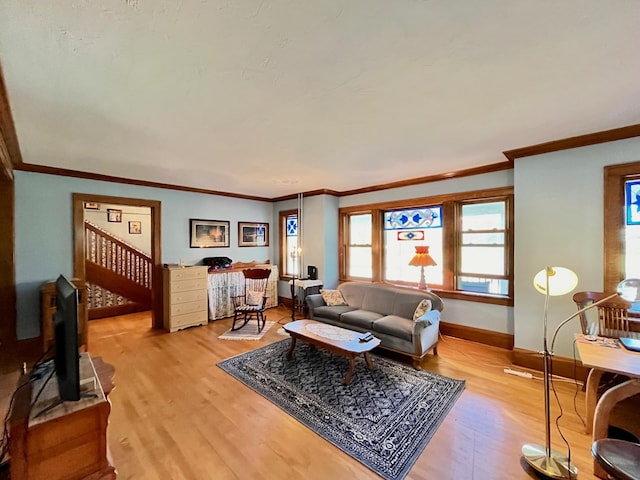 living room with crown molding and light wood-type flooring