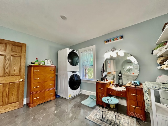 clothes washing area with stacked washer and clothes dryer