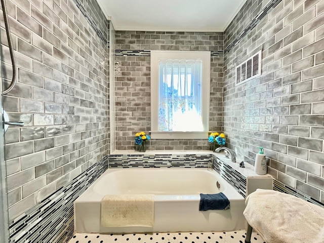 bathroom featuring a bathtub, crown molding, and tile walls