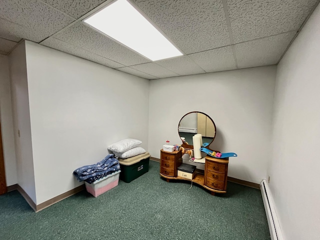 playroom with baseboard heating, a drop ceiling, and carpet