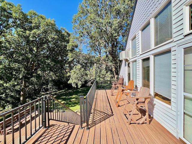 wooden deck featuring a lawn