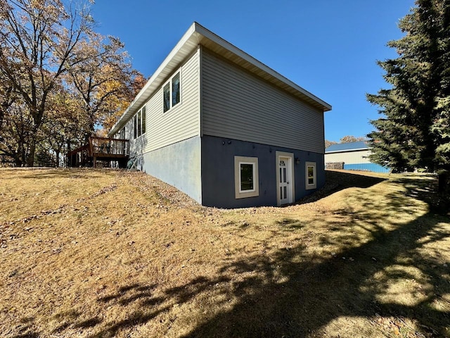 view of home's exterior with a wooden deck