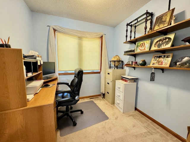 home office featuring light carpet and a textured ceiling