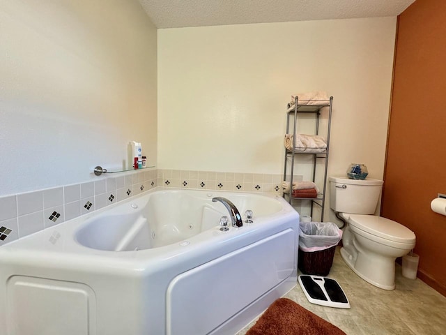 bathroom with toilet, a textured ceiling, and a tub