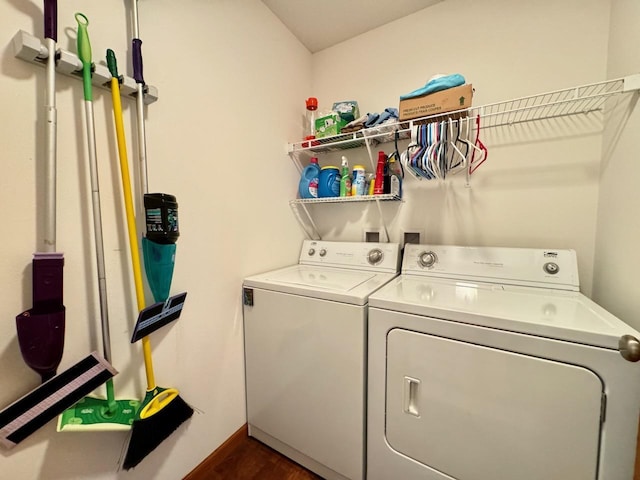 laundry area with dark hardwood / wood-style flooring and washing machine and clothes dryer