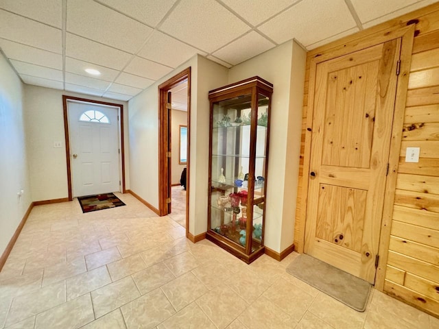 foyer entrance featuring a drop ceiling