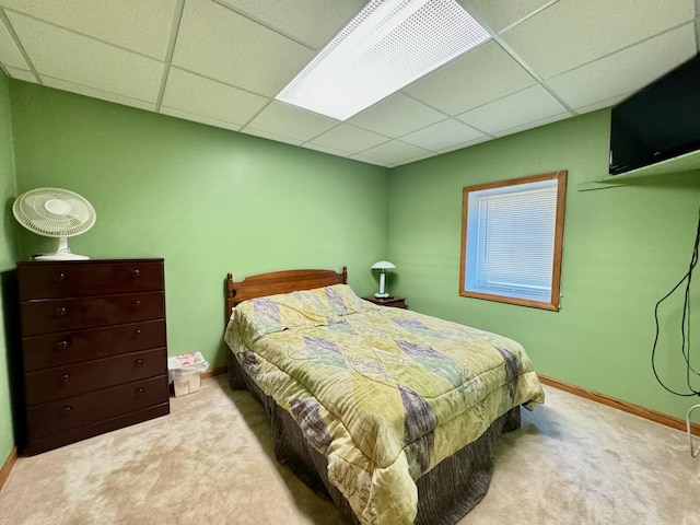 carpeted bedroom with a paneled ceiling