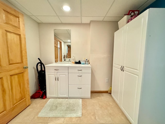 bathroom featuring vanity, a paneled ceiling, and tile patterned floors